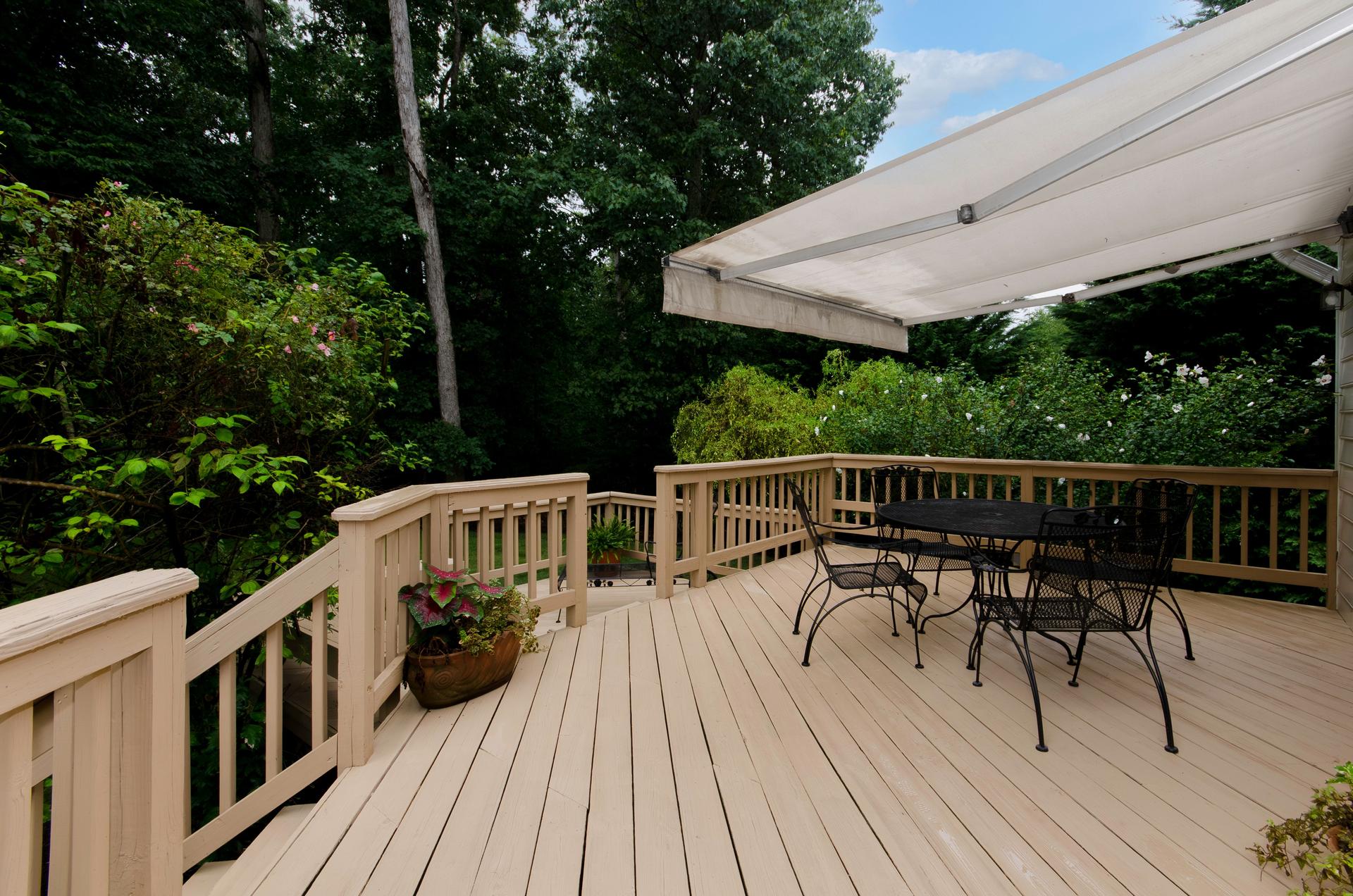 Wooden Deck with Awning and Patio Furniture